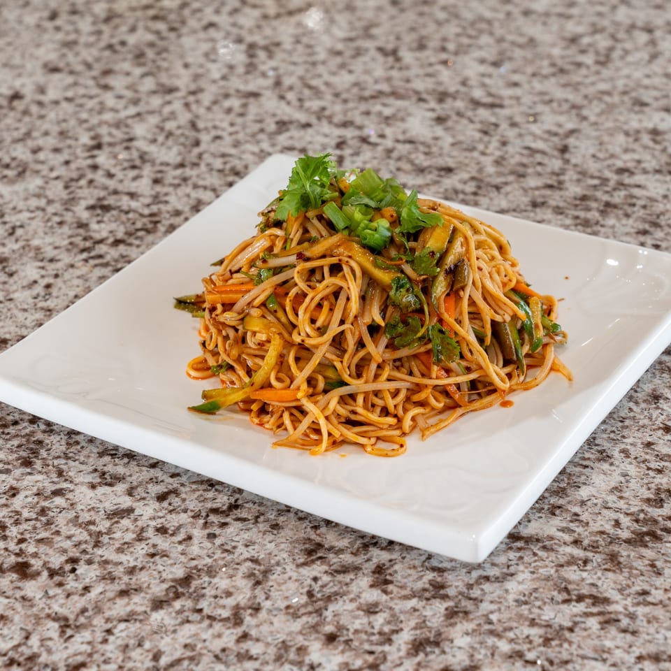 Noodles tossed with vegetables and herbs.